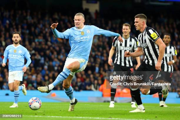 Erling Haaland of Manchester City in action with Sven Botman of Newcastle United during the Emirates FA Cup Quarter Final match between Manchester...