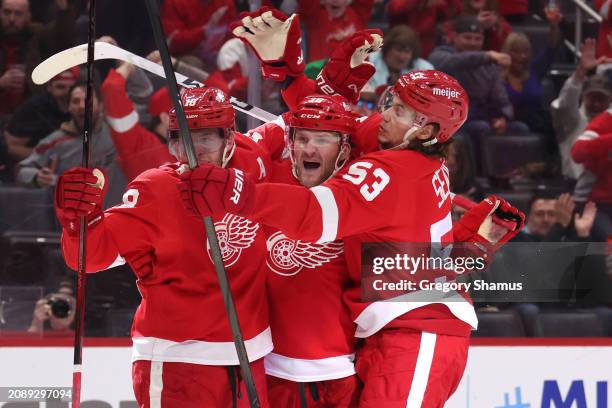 Christian Fischer of the Detroit Red Wings celebrates his second period goal against the Buffalo Sabres with Moritz Seider and Andrew Copp at Little...