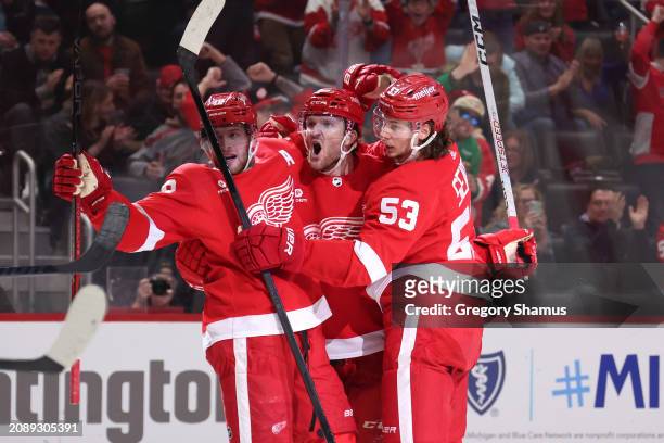 Christian Fischer of the Detroit Red Wings celebrates his second period goal against the Buffalo Sabres with Moritz Seider and Andrew Copp at Little...