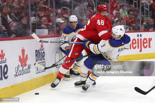 Zach Benson of the Buffalo Sabres takes a first period hit from Jeff Petry of the Detroit Red Wings at Little Caesars Arena on March 16, 2024 in...