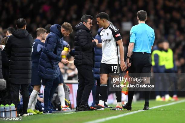 Rodrigo Muniz of Fulham speaks to Marco Silva, Manager of Fulham, after being substituted during the Premier League match between Fulham FC and...