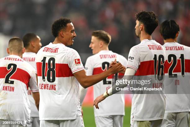 Jamie Leweling of VfB Stuttgart celebrates scoring his team's third goal with teammate Atakan Karazor during the Bundesliga match between TSG...