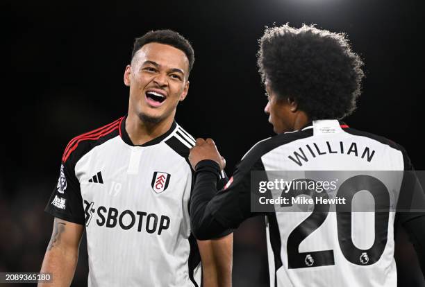 Rodrigo Muniz of Fulham celebrates scoring his team's third goal with teammate Willian during the Premier League match between Fulham FC and...