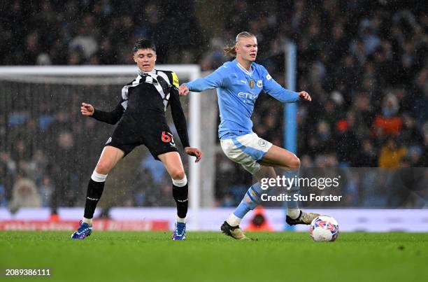 Erling Haaland of Manchester City rips the shirt of Lewis Miley of Newcastle United whilst battling for possession during the Emirates FA Cup Quarter...