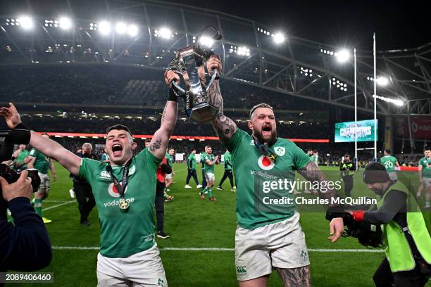 Calvin Nash and Andrew Porter of Ireland lift the Six Nations Trophy following the team's victory during the Guinness Six Nations 2024 match between...