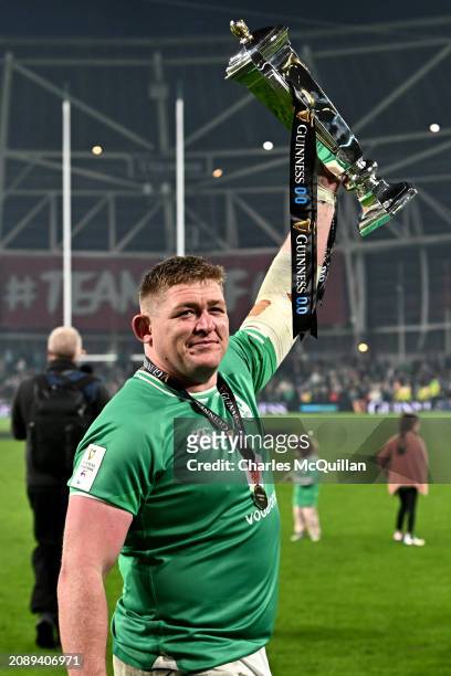 Tadhg Furlong of Ireland lifts the Six Nations Trophy following the team's victory during the Guinness Six Nations 2024 match between Ireland and...