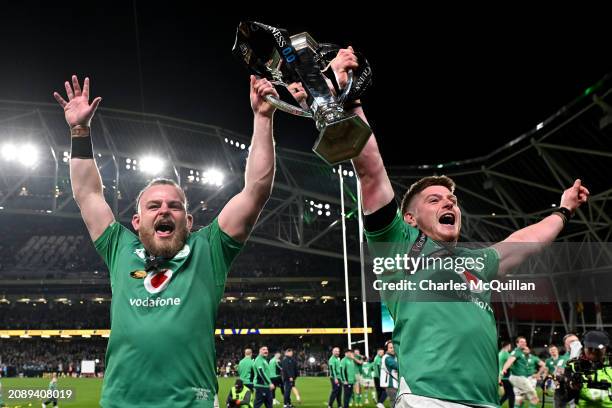 Finlay Bealham and Joe McCarthy of Ireland lift the Six Nations Trophy following the team's victory during the Guinness Six Nations 2024 match...
