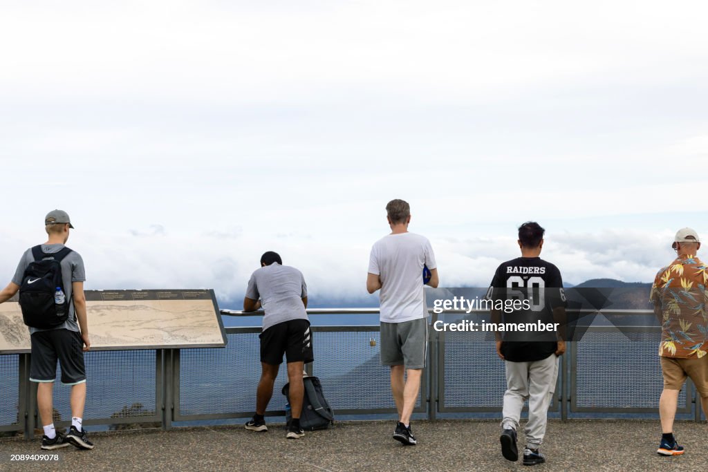 Group of men enjoying day at Mountains lookout, background with copy space