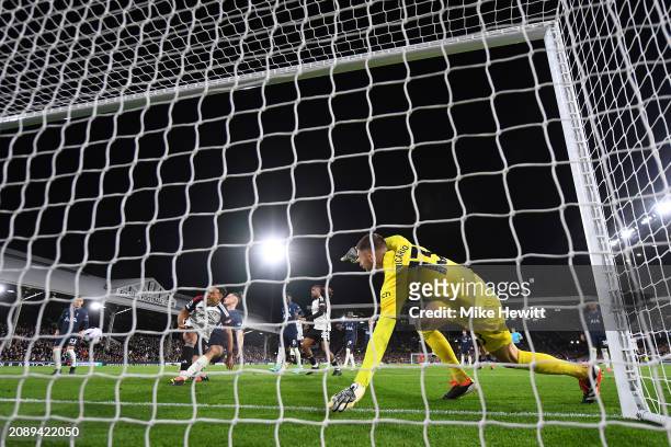 Guglielmo Vicario of Tottenham Hotspur fails to make a save as Rodrigo Muniz of Fulham scores his team's third goal during the Premier League match...