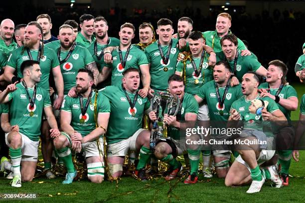 Peter O'Mahony of Ireland and the rest of the team pose for a photo with the Six Nations Trophy following the team's victory during the Guinness Six...