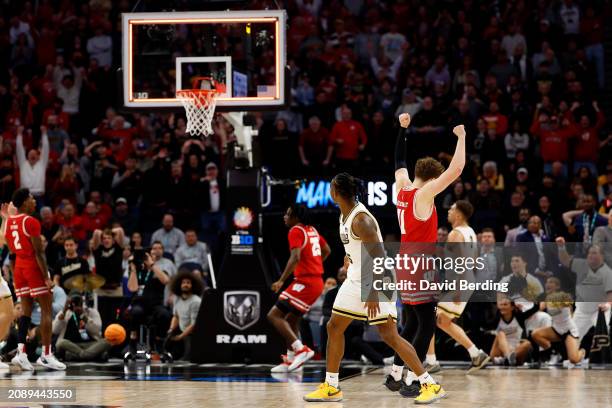 Max Klesmit of the Wisconsin Badgers celebrates as Lance Jones of the Purdue Boilermakers misses his shot to end the game at Target Center in the...