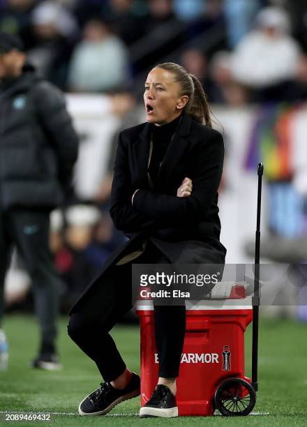 Head coach Casey Stoney of the San Diego Wave FC directs her team as she sits on an ice box during the 2024 NWSL Challenge Cup at Red Bull Arena on...