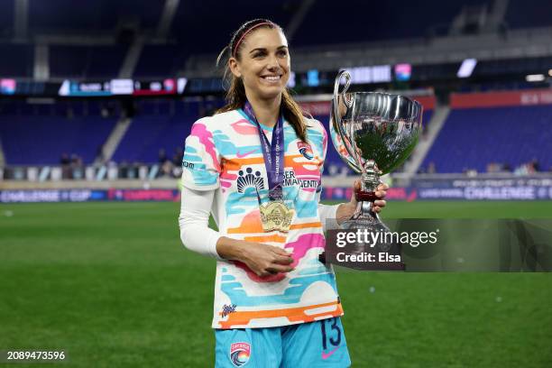 Alex Morgan of the San Diego Wave FC poses with her MVP trophy and the 2024 NWSL Challenge Cup at Red Bull Arena on March 15, 2024 in Harrison, New...