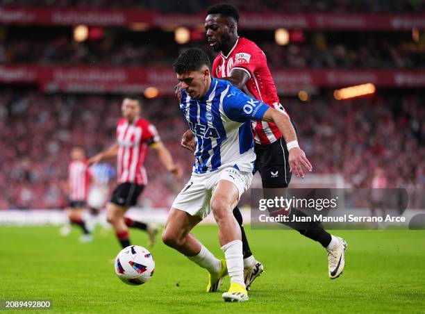 Javi Lopez of Deportivo Alaves is challenged by Inaki Williams of Athletic Club during the LaLiga EA Sports match between Athletic Bilbao and...