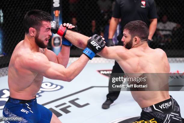 Thiago Moises of Brazil punches Mitch Ramirez in their lightweight fight during the UFC Fight Night event at UFC APEX on March 16, 2024 in Las Vegas,...