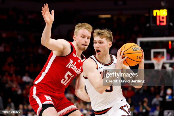 Marcus Domask of the Illinois Fighting Illini goes to the basket against Rienk Mast of the Nebraska Cornhuskers in the first half at Target Center in...