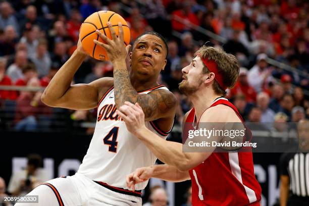 Justin Harmon of the Illinois Fighting Illini goes to the basket against Sam Hoiberg of the Nebraska Cornhuskers in the first half at Target Center...