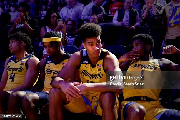 Stevie Mitchell, Chase Ross, Oso Ighodaro, and Kam Jones of the Marquette Golden Eagles look on before team introductions against the Providence...