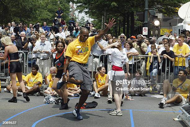 Performer dances during a street party for the unveiling of the Charlotte Bobcats expansion NBA team on June 11, 2003 in Charlotte, North Carolina....