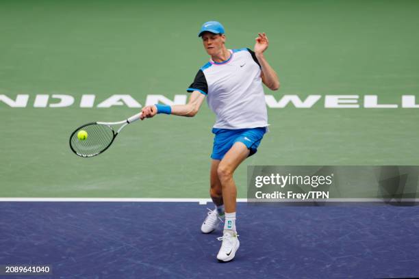Jannik Sinner of Italy hits a forehand against Carlos Alcaraz of Spain in the semi-final of the BNP Paribas Open at Indian Wells Tennis Garden on...
