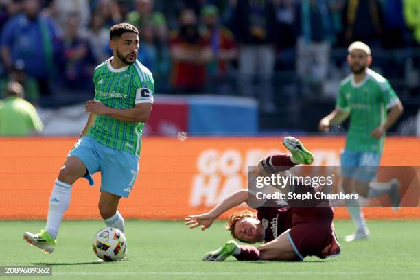 Cristian Roldan of Seattle Sounders controls the ball against Oliver Larraz of Colorado Rapids at Lumen Field on March 16, 2024 in Seattle,...