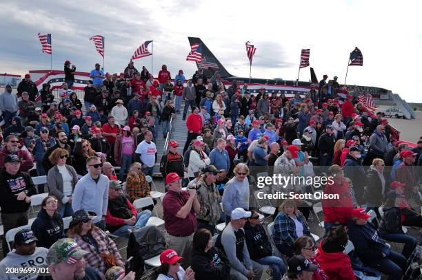 Guests listen as Republican presidential candidate former President Donald Trump speaks to supporters during a rally at the Dayton International...
