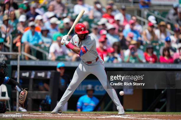 Johan Rojas of the Philadelphia Phillies at bat during a spring training game against the Miami Marlins at Roger Dean Stadium on March 16, 2024 in...