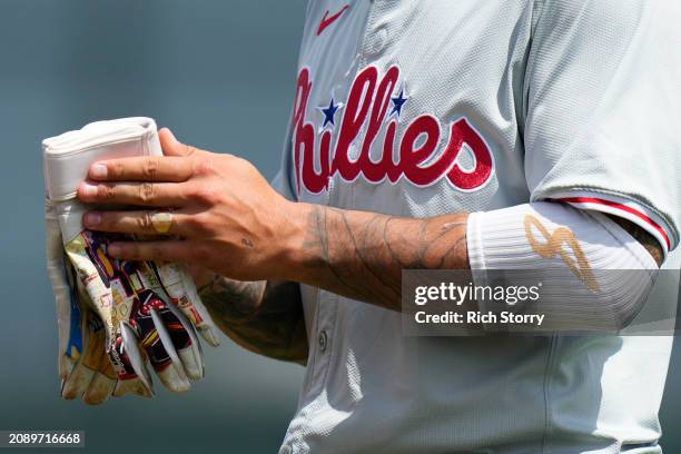 Detailed view of Nick Castellanos of the Philadelphia Phillies custom Jean Michel Basquiat batting gloves during a spring training game against the...