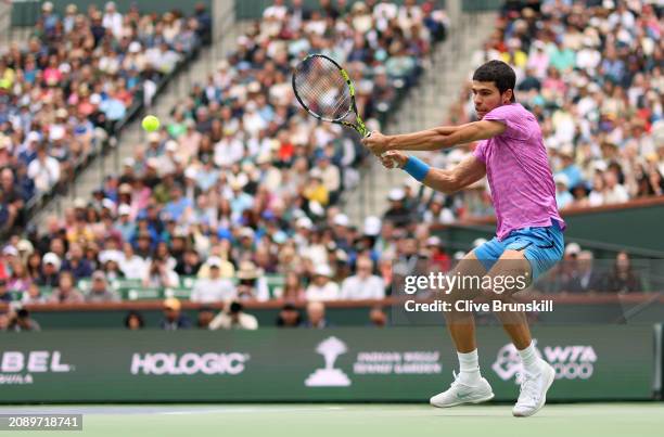 Carlos Alcaraz of Spain plays a backhand against Jannik Sinner of Italy in their Mens Semifinal match during the BNP Paribas Open at Indian Wells...