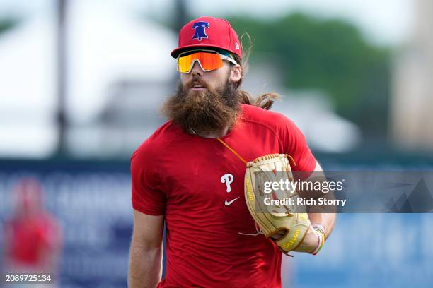 Brandon Marsh of the Philadelphia Phillies looks on prior to a spring training game against the Miami Marlins at Roger Dean Stadium on March 16, 2024...