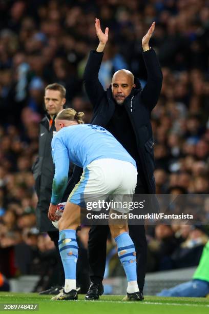 Manchester City manager Josep Guardiola gestures on the touchline in front of Erling Haaland during the Emirates FA Cup Quarter Final match between...