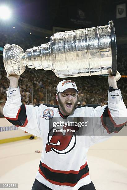 John Madden of the New Jersey Devils holds up the Stanley Cup after defeating the Mighty Ducks of Anaheim 3-0 in game seven of the 2003 Stanley Cup...