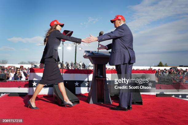 Republican presidential candidate former President Donald Trump greets South Dakota Gov. Kristi Noem during a rally at the Dayton International...