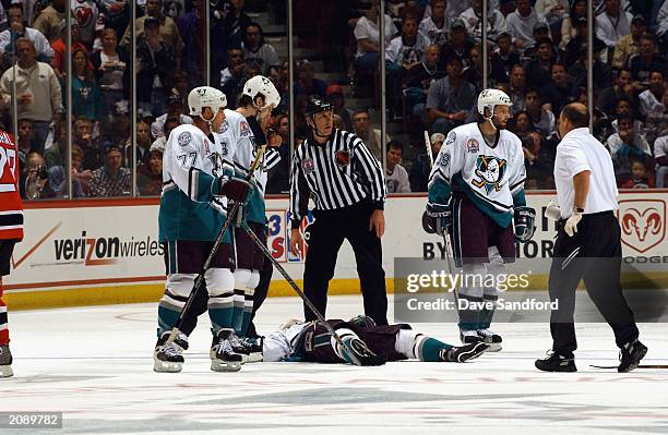 Paul Kariya of the Mighty Ducks of Anaheim lays on the ice after being checked by Scott Stevens of the New Jersey Devils in Game Six of the 2003...