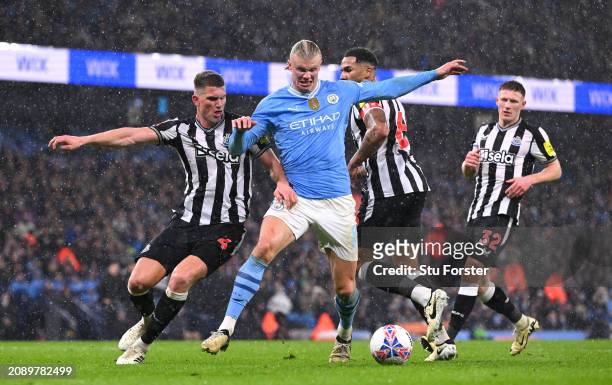 Manchester City player Erling Haaland is challenged by Sven Botman of Newcastle during the Emirates FA Cup Quarter Final match between Manchester...