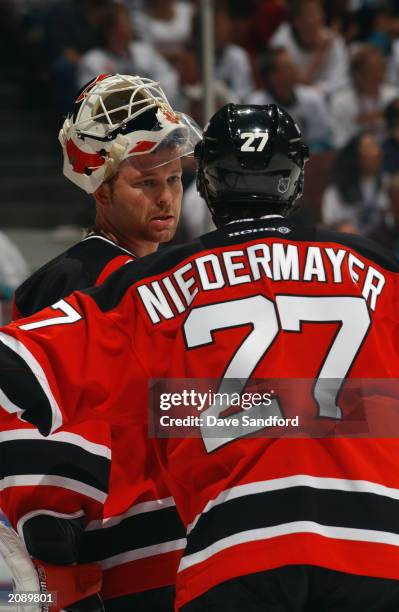 Martin Brodeur of the New Jersey Devils has a discussion with teammate Scott Niedermayer against the Mighty Ducks of Anaheim in Game Six of the 2003...