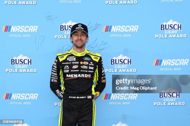 Ryan Blaney, driver of the Menards/Dutch Boy Ford, poses for photos after winning the pole award during qualifying for the NASCAR Cup Series Food...