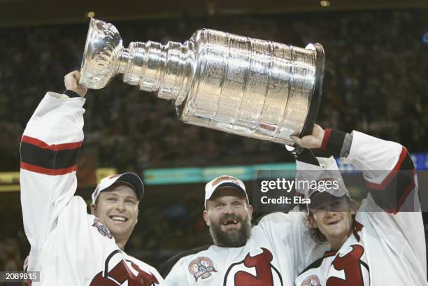 Goalie Martin Brodeur, Ken Daneyko and Patrik Elias of the New Jersey Devils hold up the Stanley Cup after defeating the Mighty Ducks of Anaheim 3-0...