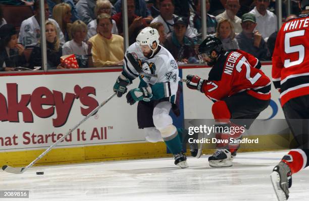 Rob Niedermayer of the Mighty Ducks of Anaheim skates past his brother Scott Niedermayer of the New Jersey Devils in Game Six of the 2003 Stanley Cup...