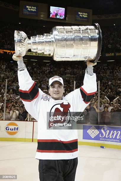 Jamie Langenbrunner of the New Jersey Devils holds up the Stanley Cup after defeating the Mighty Ducks of Anaheim 3-0 in game seven of the 2003...