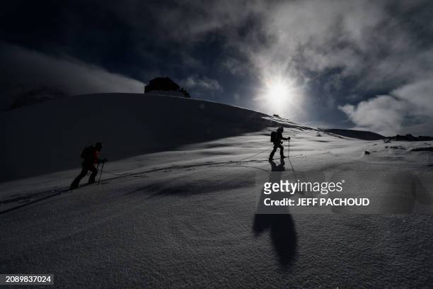 French mountaineer Charles Dubouloz and French skipper Jeremie Beyou congratulate each other at the end of a mountaineering day, in the Mont Blanc...