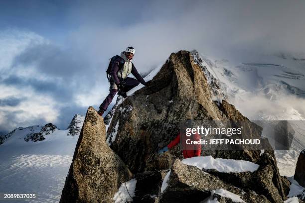 French mountaineer Charles Dubouloz and French skipper Jeremie Beyou stand on a ridge of the Glacier Du Geant near the Cosmiques hut, in the Mont...