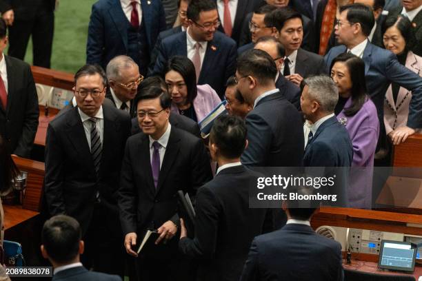 John Lee, Hong Kong's chief executive, center, following the passing of Basic Law Article 23 legislation at the Legislative Council in Hong Kong,...