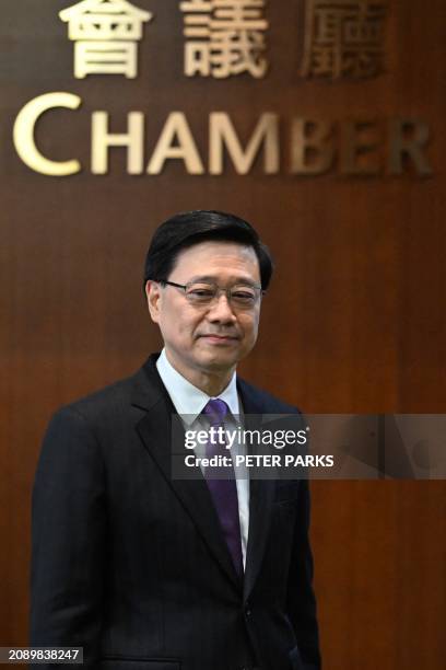 Chief Executive John Lee arrives to speak to the media in the Legislative Council building after the passing of the Article 23 National Security Law...