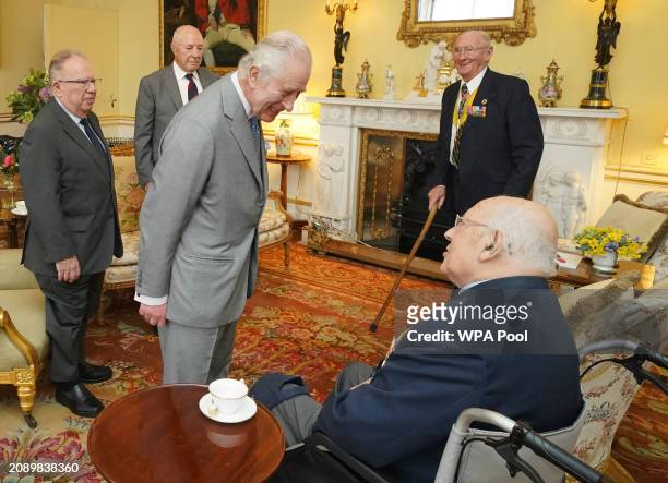 King Charles III , during an audience with Veterans of the Korean War Alan Guy, Mike Mogridge, Brian Parritt, and Ron Yardley at Buckingham Palace on...