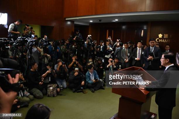 Chief Executive John Lee speaks to the media in the Legislative Council building after the passing of the Article 23 National Security Law in Hong...