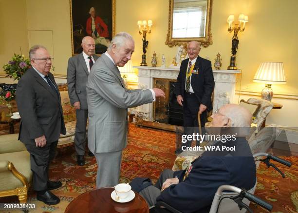 King Charles III , during an audience with Veterans of the Korean War Alan Guy, Mike Mogridge, Brian Parritt, and Ron Yardley at Buckingham Palace on...