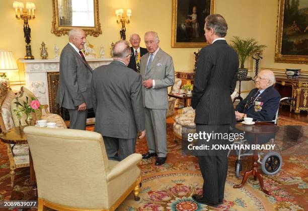 Britain's King Charles III and Master of The King's Household, Vice Admiral Tony Johnstone-Burt talk with Veterans of the Korean War including Mike...