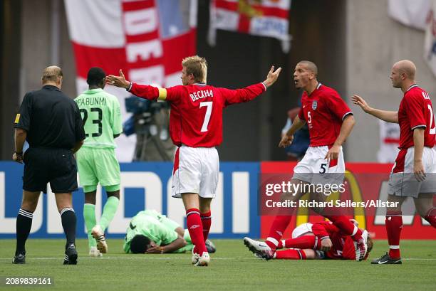 June 12: David Beckham and Rio Ferdinand of England react during the FIFA World Cup Finals 2002 Group F match between Nigeria and England at Osaka...