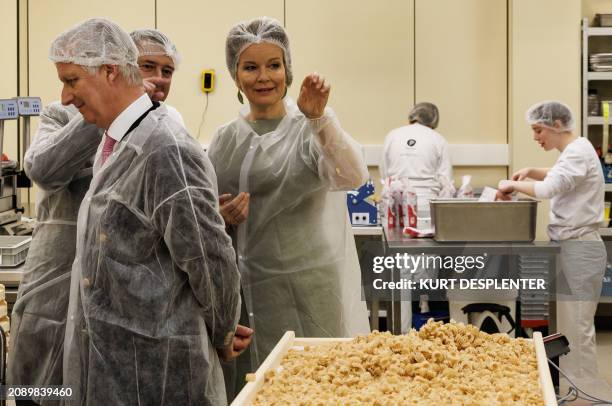 King Philippe - Filip of Belgium and Queen Mathilde of Belgium are pictured during a royal visit to Aarova, a custom company that produces textiles...